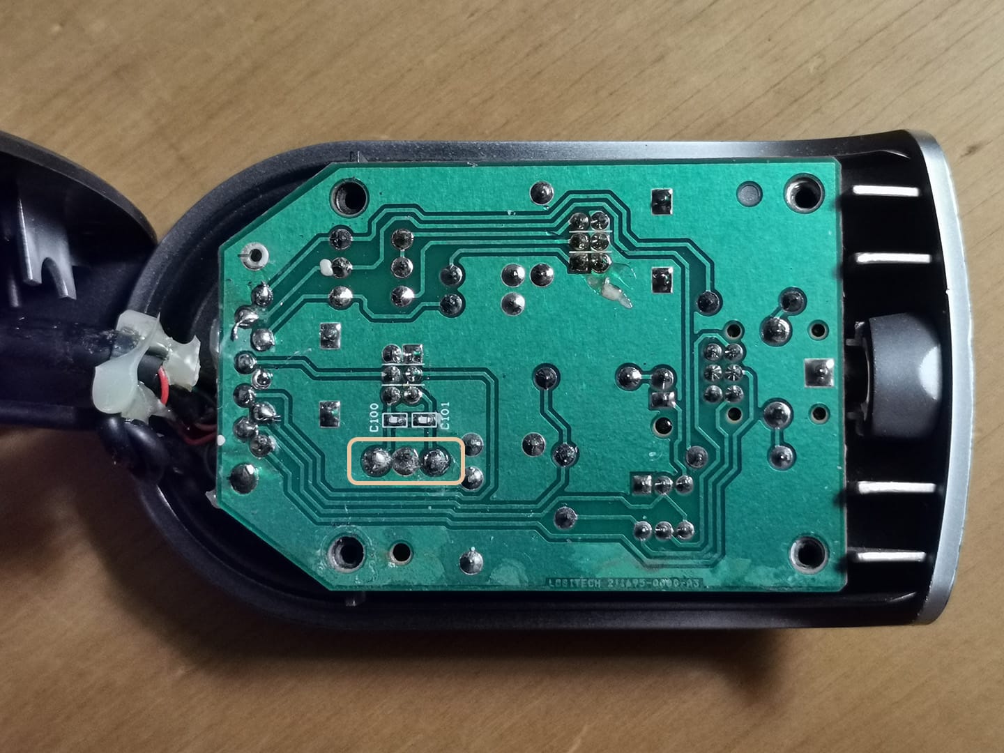 The soldered wires in the previous picture are located on the logic board indicated by the circled region.