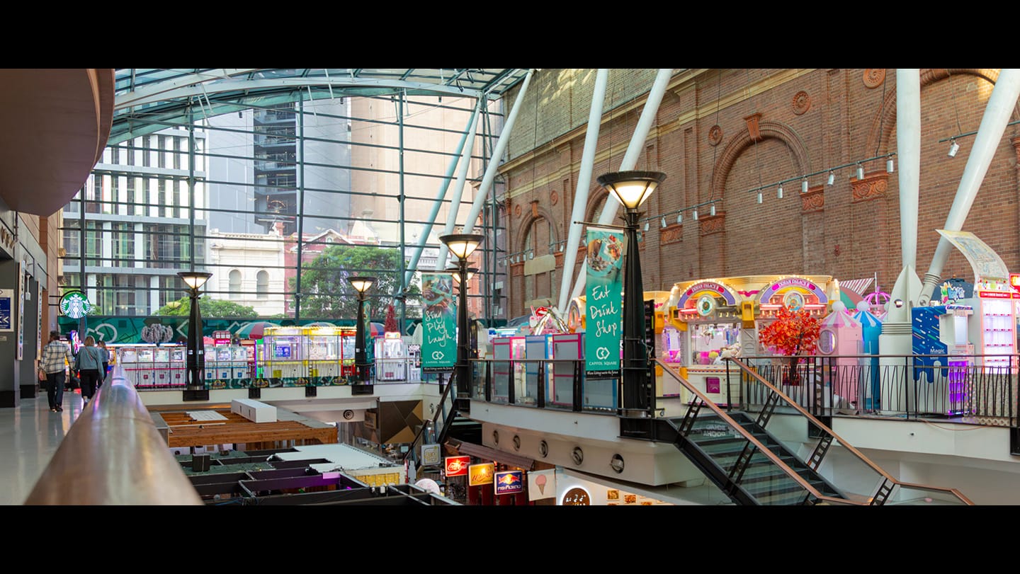 A letterbox cropped image of Purikura Photoland’s floor facing northbound, showing their various claw machines.